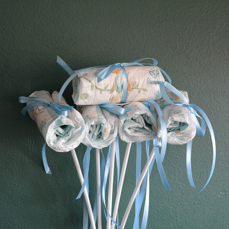 Windel Einstecker mit blauen Schleifen auf weißen Stäben, liebevolles Add-on für It's a Boy Blumen liefern lassen zur Geburt.